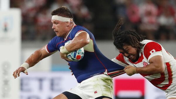 Rugby Union - Rugby World Cup 2019 - Pool A - Japan v Russia - Tokyo Stadium, Tokyo, Japan - September 20, 2019 Russia's Vitaly Zhivatov in action with Japan's Shota Horie  - Sputnik International