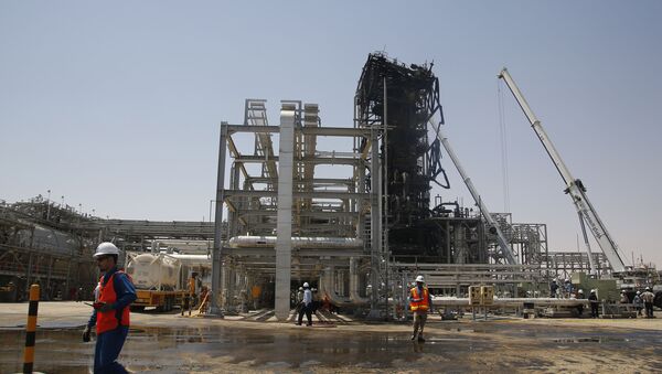 In this photo opportunity during a trip organized by Saudi information ministry, a worker walks in front of the Khurais oil field in Khurais, Saudi Arabia, Friday, Sept. 20, 2019, after it was hit during Sept. 14 attack. - Sputnik International