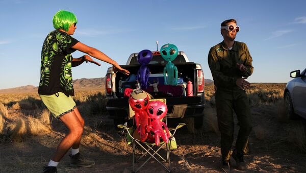 FILE PHOTO: Two men dance on a road to an entrance to Area 51 as an influx of tourists responding to a call to 'storm' Area 51, a secretive U.S. military base believed by UFO enthusiasts to hold government secrets about extra-terrestrials, is expected in Rachel, Nevada, U.S. September 20, 2019. REUTERS/Jim Urquhart/File Photo - Sputnik International