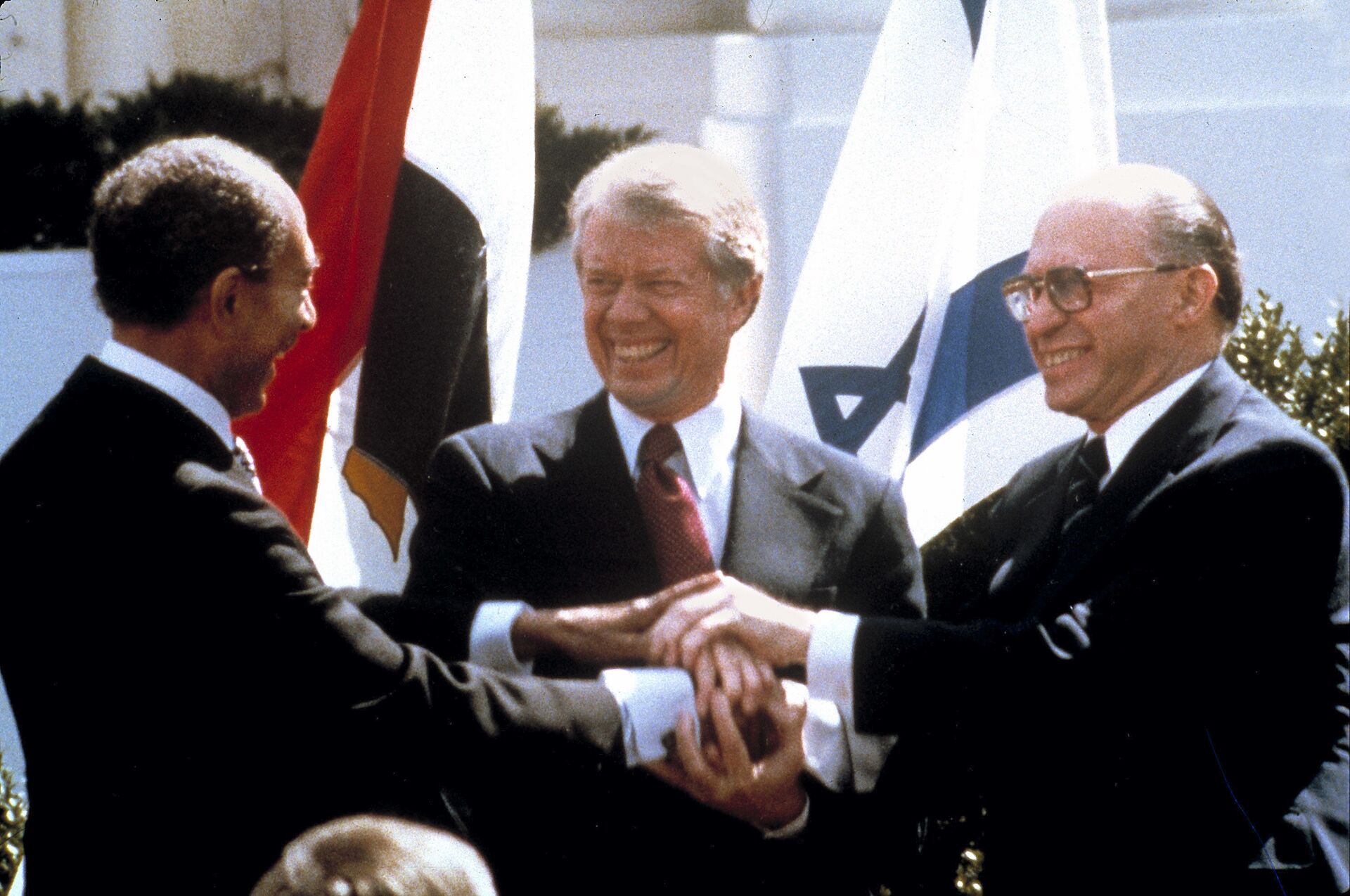 In this file photo taken March 26, 1979, Egyptian President Anwar Sadat,left, U.S. President Jimmy Carter, center, and Israeli Prime Minister Menachem Begin clasp hands on the north lawn of the White House as they completed signing of the peace treaty between Egypt and Israel. When Israeli Prime Minister Menachem Begin shook hands with Egyptian President Anwar Sadat on the White House lawn on March 26, 1979, ordinary Israelis saw not only an end to war with their largest neighbor but also the hope of warm relations with the people next door - Sputnik International, 1920, 13.10.2023