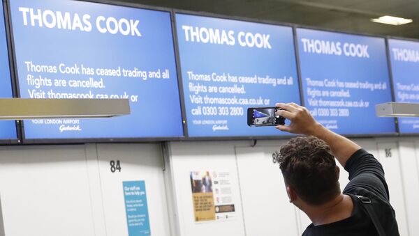 John Garret from Boston Ma., who was supposed to be flying to Malta, takes a photo of the empty Thomas Cook check in desks in Gatwick Airport, England Monday, Sept. 23, 2019. - Sputnik International