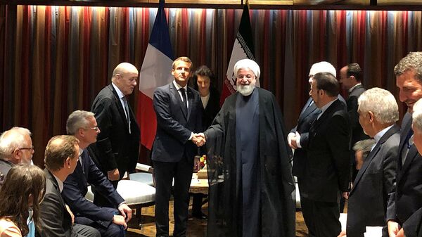 French President Emmanuel Macron shakes hands with Iranian President Hassan Rouhani during their meeting on the sidelines of the United Nations General Assembly in New York, U.S., September 23, 2019 - Sputnik International
