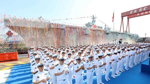People's Liberation Army Navy officers attend the launch ceremony for China's first amphibious assault ship in Shanghai on Sept 25, 2019 - Sputnik International