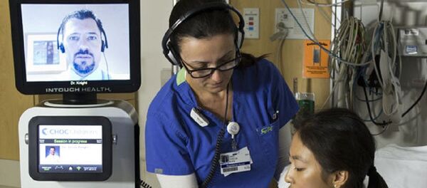 A nurse checks a patient’s vitals during a consultation by the RP-VITA robotic doctor A nurse checks a patient’s vitals during a consultation by the RP-VITA robotic doctor - Sputnik International