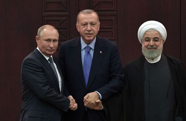 President of Russia Vladimir Putin, Turkish President Recep Tayyip Erdogan and Iranian President Hassan Rouhani during a joint press conference after the 5th Trilateral Summit in Astana format on the Syrian crisis   - Sputnik International