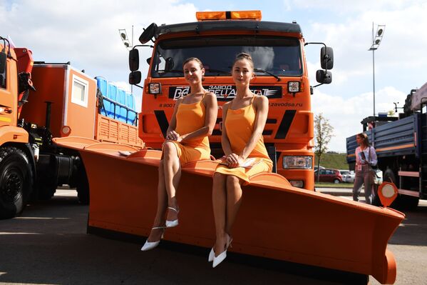 Promotional models pose for pictures near KAMAZ vehicles at the Comtrans 2019 international exhibition in Moscow.   - Sputnik International
