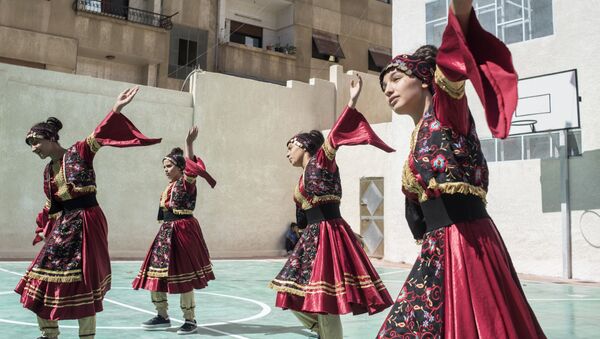 Girls in national costumes perform during the opening of a school in Barzeh district in Damascus - Sputnik International