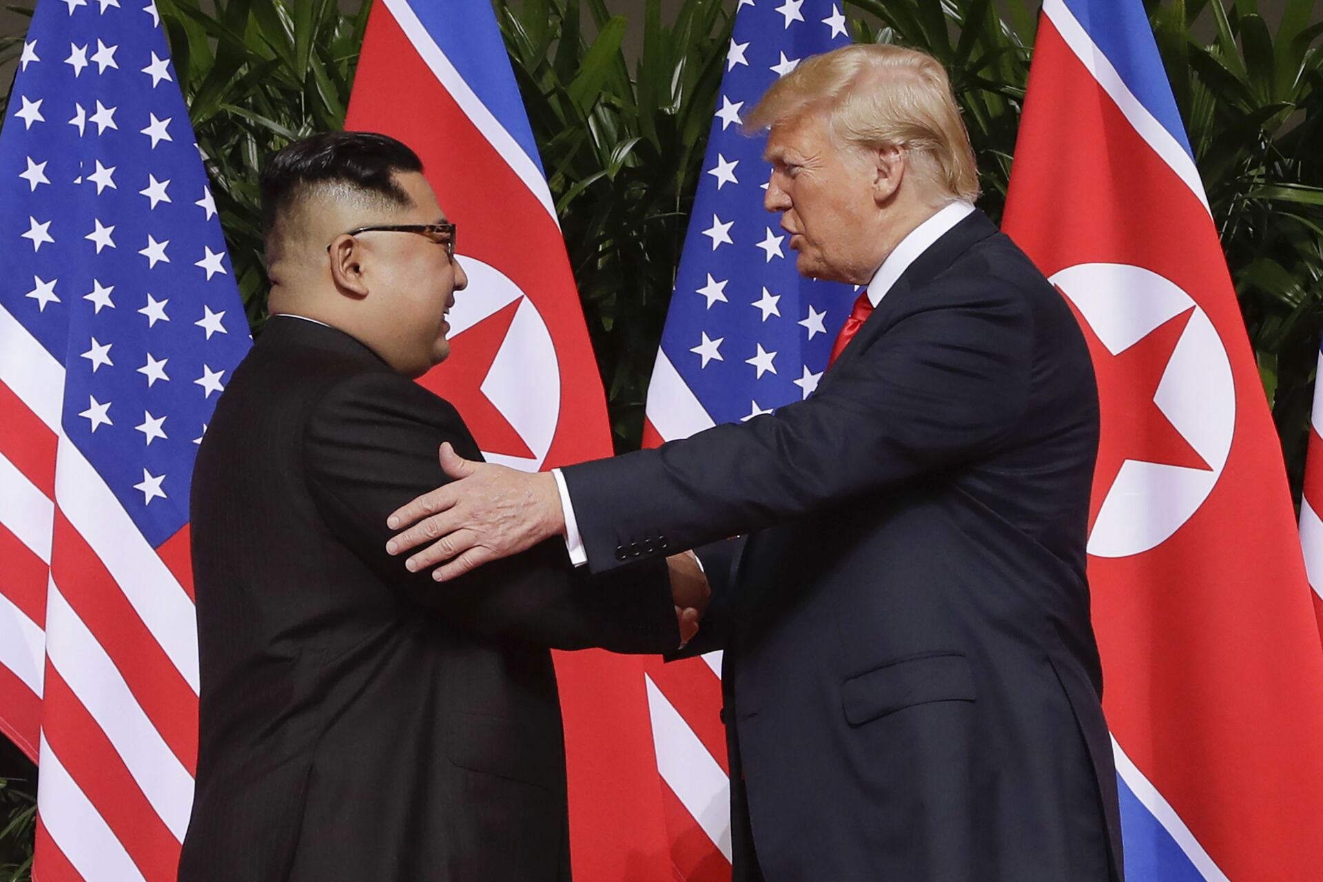 n this June 12, 2018 file photo, U.S. President Donald Trump, right, shakes hands with North Korea leader Kim Jong Un at the Capella resort on Sentosa Island in Singapore. Kim’s fifth meeting with Chinese President Xi Jinping continues his ambitious diplomatic outreach that has included summits with the leaders of the United States, South Korea and Russia in the past year and a half. Experts say Kim is attempting to form a united front with North Korea’s main ally China to strengthen his leverage in the stalled nuclear negotiations with the United States.  - Sputnik International, 1920, 28.10.2022