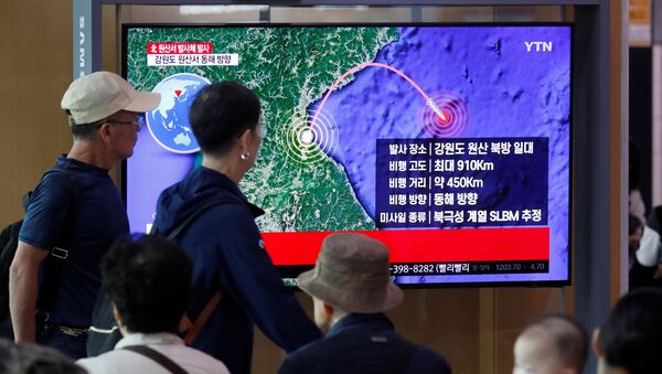 People watch a TV broadcasting a news report on North Korea firing a missile that is believed to be launched from a submarine, in Seoul, South Korea, October 2, 2019 - Sputnik International