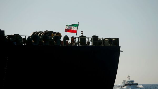  A crew member raises the Iranian flag at Iranian oil tanker Adrian Darya 1, formerly named Grace 1, as it sits anchored after the Supreme Court of the British territory lifted its detention order, in the Strait of Gibraltar, Spain, August 18, 2019 - Sputnik International