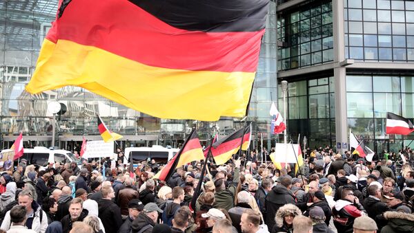 Participants of the right-wing demonstration Day of the Nation called by the Alliance We for Germany (Wir fuer Deutschland) gather with German flags at the main station during the German Unification Day in Berlin, Germany, on October 3, 2018. - Sputnik International