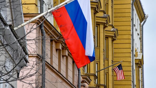 US national flag  waves on the building of the embassy of the United States of America (R) in Moscow on April 2, 2018 - Sputnik International