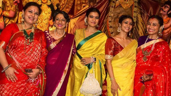 Bollywood actresses Sharbani Mukherjee (L), Tanuja (2L), Kajol Devgan (C), Tanisha Mukherjee (2R) and Rani Mukherjee (R) pose for photographs during 'Durja Puja' celebrations at the 72nd North Bombay Sarbojanin Durga Puja Samiti festival in Mumbai on October 6, 2019.  - Sputnik International