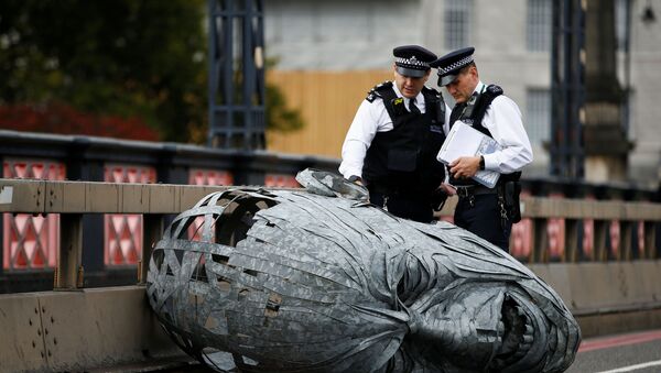 Police officers look at a sculpture made by activists at Lambeth Bridge during the Extinction Rebellion protest in London, Britain October 7, 2019 - Sputnik International