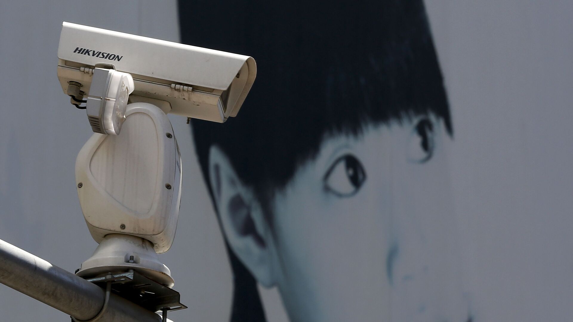 A video surveillance camera made by China's Hikvision is mounted on top of a street near a advertisement poster in Beijing. - Sputnik International, 1920, 13.03.2023