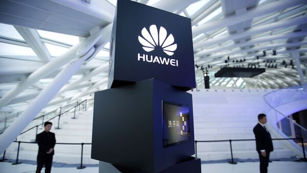 In this May 26, 2016 photo, security personnel stand near a pillar with the Huawei logo at a launch event for the Huawei MateBook in Beijing. Huawei Technology Ltd., the Chinese smartphone and telecom equipment maker, said Friday, March 30, 2018, that its 2017 profit rose 28.1 percent, boosted by strong sales for its enterprise and consumer units - Sputnik International