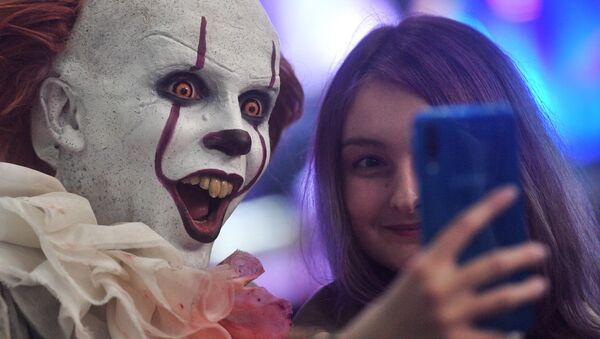 A visitor and a cosplayer at the IgroMir 2019 exhibition and the Comic Con Russia 2019 festival at the International Crocus Expo Exhibition Centre in Moscow.   - Sputnik International