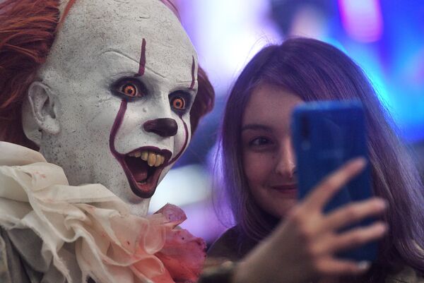 A visitor and a cosplayer at the IgroMir 2019 exhibition and the Comic Con Russia 2019 festival at the International Crocus Expo Exhibition Centre in Moscow.   - Sputnik International