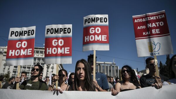 Communist-affiliated protesters hold placards as they take part in a demonstration to protest against the visit of US Secretary of State Mike Pompeo in Athens on October 5, 2019. - Sputnik International
