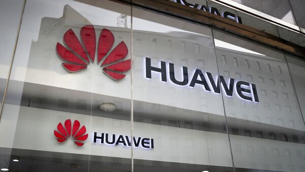 FILE - In this Jan. 29, 2019, file photo, the logos of Huawei are displayed at its retail shop window reflecting the Ministry of Foreign Affairs office in Beijing - Sputnik International