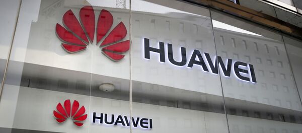 FILE - In this Jan. 29, 2019, file photo, the logos of Huawei are displayed at its retail shop window reflecting the Ministry of Foreign Affairs office in Beijing FILE - In this Jan. 29, 2019, file photo, the logos of Huawei are displayed at its retail shop window reflecting the Ministry of Foreign Affairs office in Beijing - Sputnik International