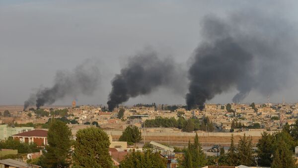 Smoke rises from the Syrian border town of Ras al-Ain as it is pictured from the Turkish town of Ceylanpinar in Sanliurfa province, Turkey, October 9, 2019 - Sputnik International