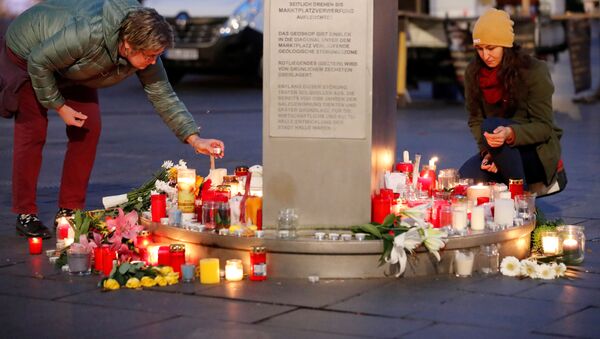 People place candles at central market square in Halle, Germany October 10, 2019, after two people were killed in a shooting - Sputnik International