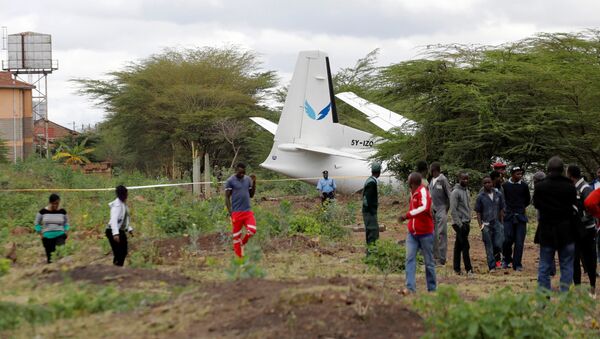 Bystanders watch the Fokker 50, 5Y-IZO plane operated by Silverstone Air that crash landed after take-off from the Wilson Airport in Nairobi, Kenya October 11, 2019 - Sputnik International