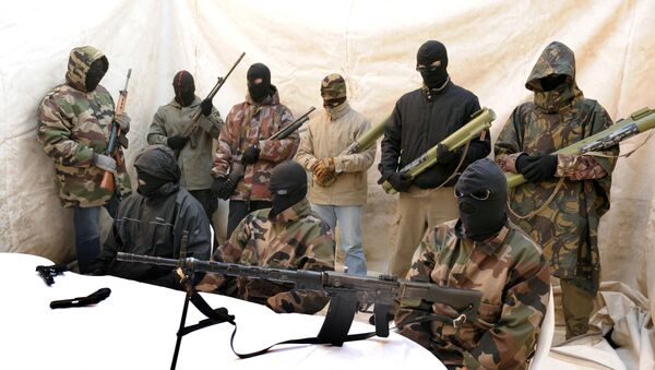 Hooded and clad in military fatigues, armed with guns, rocket launchers, members of a commando claiming to belong to the National Liberation Front of Corsica answer media questions at a press conference held near Ajaccio on May,2010 - Sputnik International