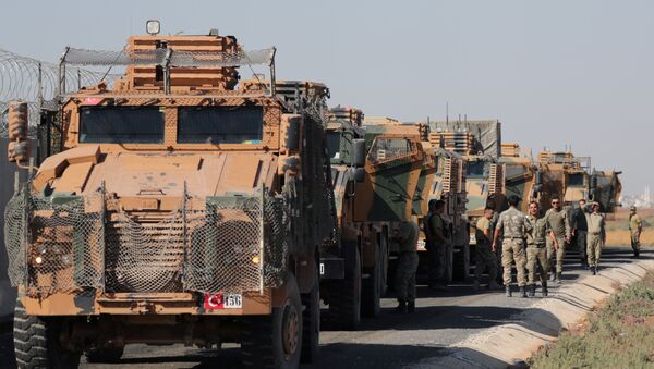Turkish soldiers stand near military trucks in the village of Yabisa, near the Turkish-Syrian border, Syria, October 12, 2019. REUTERS/Khalil Ashawi - Sputnik International