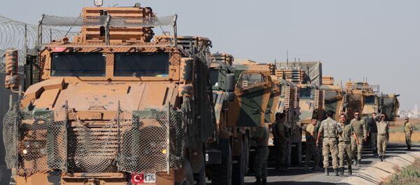 Turkish soldiers stand near military trucks in the village of Yabisa, near the Turkish-Syrian border, Syria, October 12, 2019. REUTERS/Khalil Ashawi Turkish soldiers stand near military trucks in the village of Yabisa, near the Turkish-Syrian border, Syria, October 12, 2019. REUTERS/Khalil Ashawi - Sputnik International