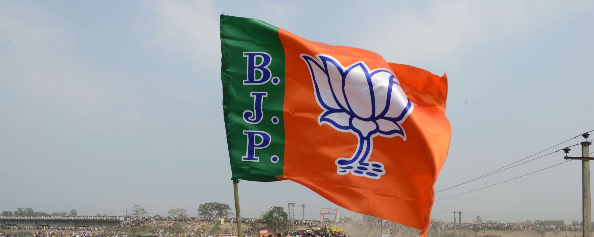 Indian supporters of the Bharatiya Janata Party (BJP) carry a party flag on their way to attend a campaign rally while wearing masks of Indian Prime Minister Narendra Modi ahead of the national elections in Siliguri on April 3, 2019 - Sputnik International, 1920, 15.02.2021