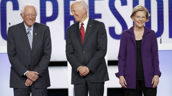 Democratic presidential candidate Sen. Bernie Sanders, I-Vt., former Vice President Joe Biden, center, and Sen. Elizabeth Warren, D-Mass., right, stand on stage before a Democratic presidential primary debate hosted by CNN and The New York Times at Otterbein University, Tuesday, Oct. 15, 2019, in Westerville, Ohio.  - Sputnik International