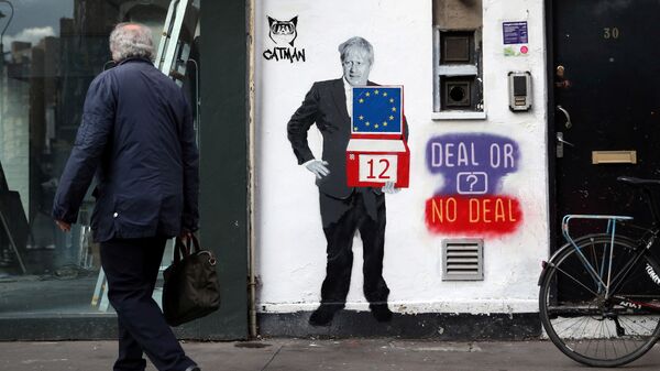 A man walks past a mural depicting Britain's Prime Minister Boris Johnson on the side of a residential building in London, Britain, October 15, 2019 - Sputnik International