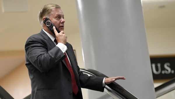 Sen. Lindsey Graham, R-S.C., talks on the phone as he rides the escalator on Capitol Hill in Washington, Wednesday, July 10, 2019, as he heads to a briefing on election security - Sputnik International