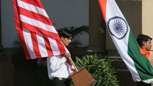 Indian workers carry the U.S. flag, left, and the Indian flag at Hyderabad House, the venue of the talks between U.S. President George W. Bush and Indian Prime Minister Manmohan Singh in New Delhi, India, Thursday, March 2, 2006 - Sputnik International