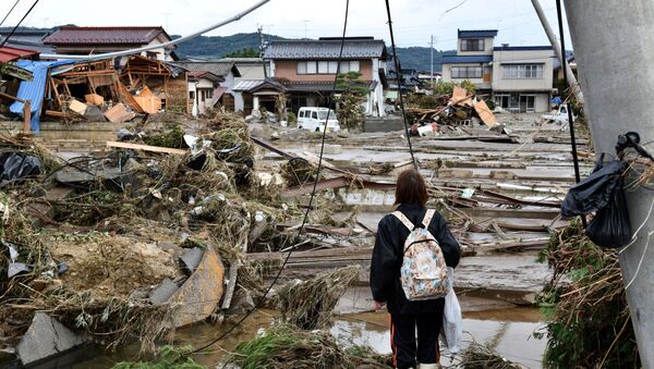 A woman looks at flood-damaged homes in Nagano on October 15, 2019, after Typhoon Hagibis hit Japan on October 12 unleashing high winds, torrential rain and triggered landslides and catastrophic flooding. - Rescuers in Japan worked into a third day on October 15 in an increasingly desperate search for survivors of a powerful typhoon that killed nearly 70 people and caused widespread destruction.  - Sputnik International
