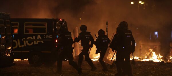 Police take position by burning barricades on the fifth day of protests over the conviction of a dozen Catalan independence leaders in Barcelona, Spain, Friday, Oct. 18, 2019.  - Sputnik International
