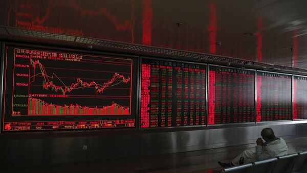 An investor sits near an electronic board displaying stock prices at a brokerage house in Beijing, Wednesday, Oct. 16, 2019. - Sputnik International