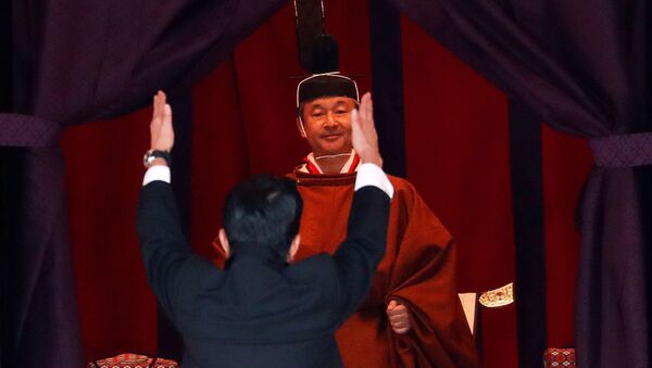 Japan's Prime Minister Shinzo Abe raises his hands as he shouts “banzai” or cheers in front of Emperor Naruhito during a ceremony to proclaim Emperor Naruhito's enthronement to the world, called Sokuirei-Seiden-no-gi, at the Imperial Palace in Tokyo, Japan October 22, 2019 - Sputnik International