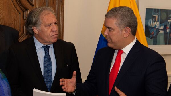 Colombia's President Ivan Duque speaks with OAS General Secretary Luis Almagro, after handing over a report that, according to Colombian authorities, contains evidence of the Venezuelan President Nicolas Maduro’s support for terrorist groups, in Washington, U.S., September 26, 2019. Picture taken September 26, 2019.  - Sputnik International
