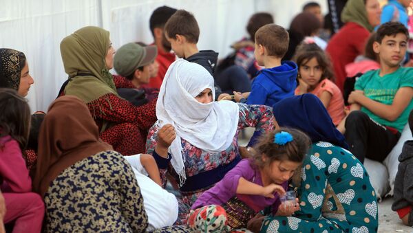 Syrian displaced families, who fled violence after the Turkish offensive in Syria, are seen at a refugee camp in Bardarash on the outskirts of Dohuk, Iraq October 25, 2019 - Sputnik International