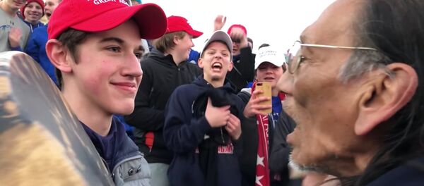 AGA-wearing US high-school students in Washington DC surround and mock Native American chanting to honor war dead, Friday, January 18, 2019. AGA-wearing US high-school students in Washington DC surround and mock Native American chanting to honor war dead, Friday, January 18, 2019. - Sputnik International