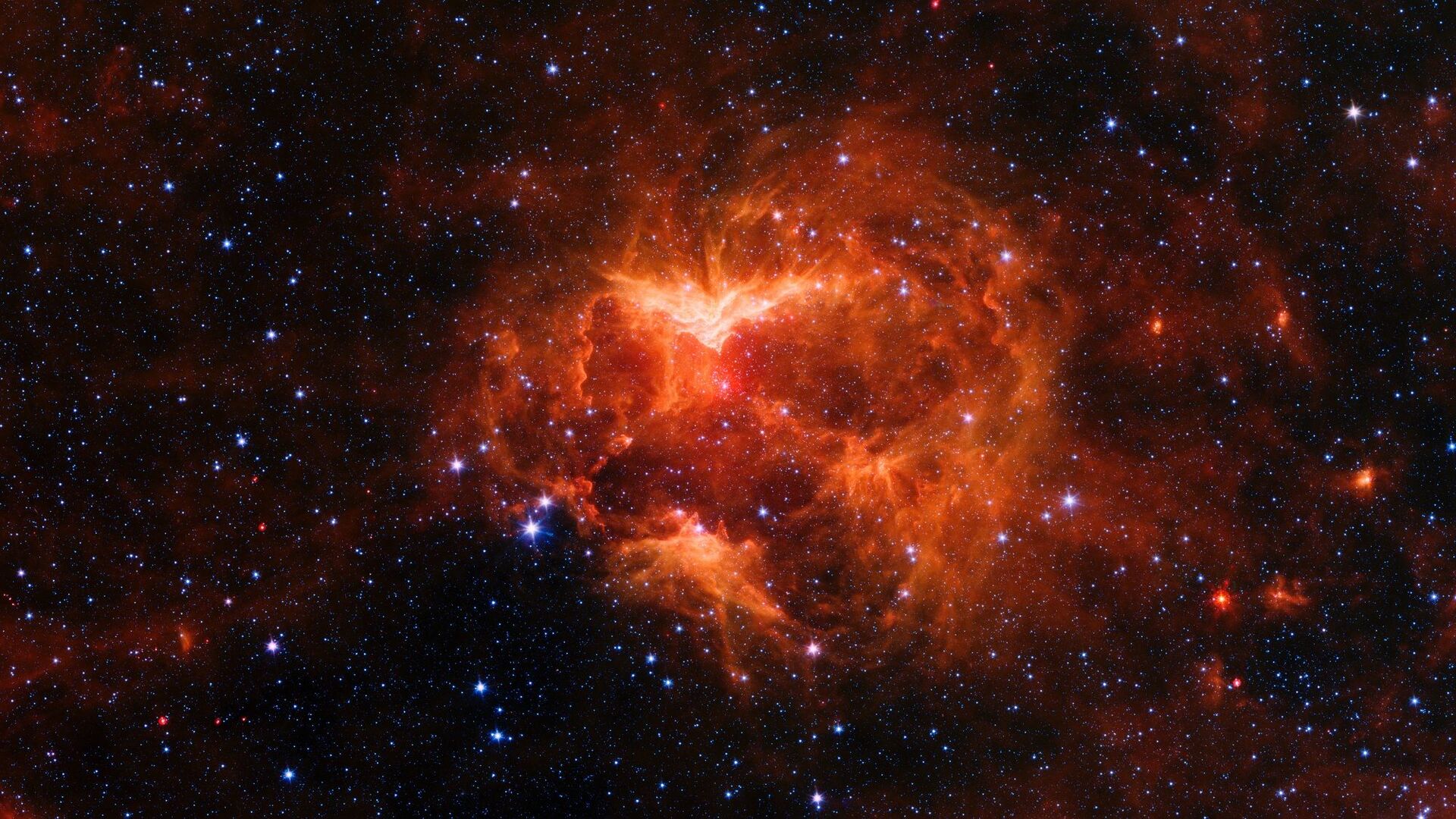 This infrared image from NASA's Spitzer Space telescope shows a cloud of gas and dust carved out by a massive star. A drawing overlaid on the image reveals why researchers nicknamed this region the Jack-o'-lantern Nebula. - Sputnik International, 1920, 30.03.2022