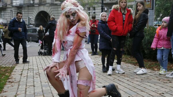 A person dressed as a Zombie poses for a photo as she participates in a 'Zombie Walk' on the weekend before Halloween in central Kiev, Ukraine Saturday, Oct. 26, 2019.  - Sputnik International