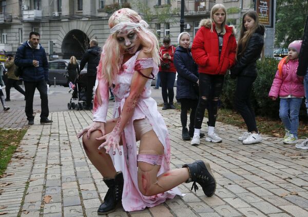 A person dressed as a Zombie poses for a photo as she participates in a 'Zombie Walk' on the weekend before Halloween in central Kiev, Ukraine Saturday, Oct. 26, 2019.  - Sputnik International