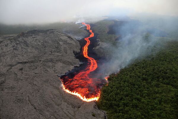 This picture taken on October 25, 2019 shows lava from the Piton de la Fournaise (Peak of the Furnace) flowing down the east-south-east face on the Indian Ocean island of Reunion. - Sputnik International