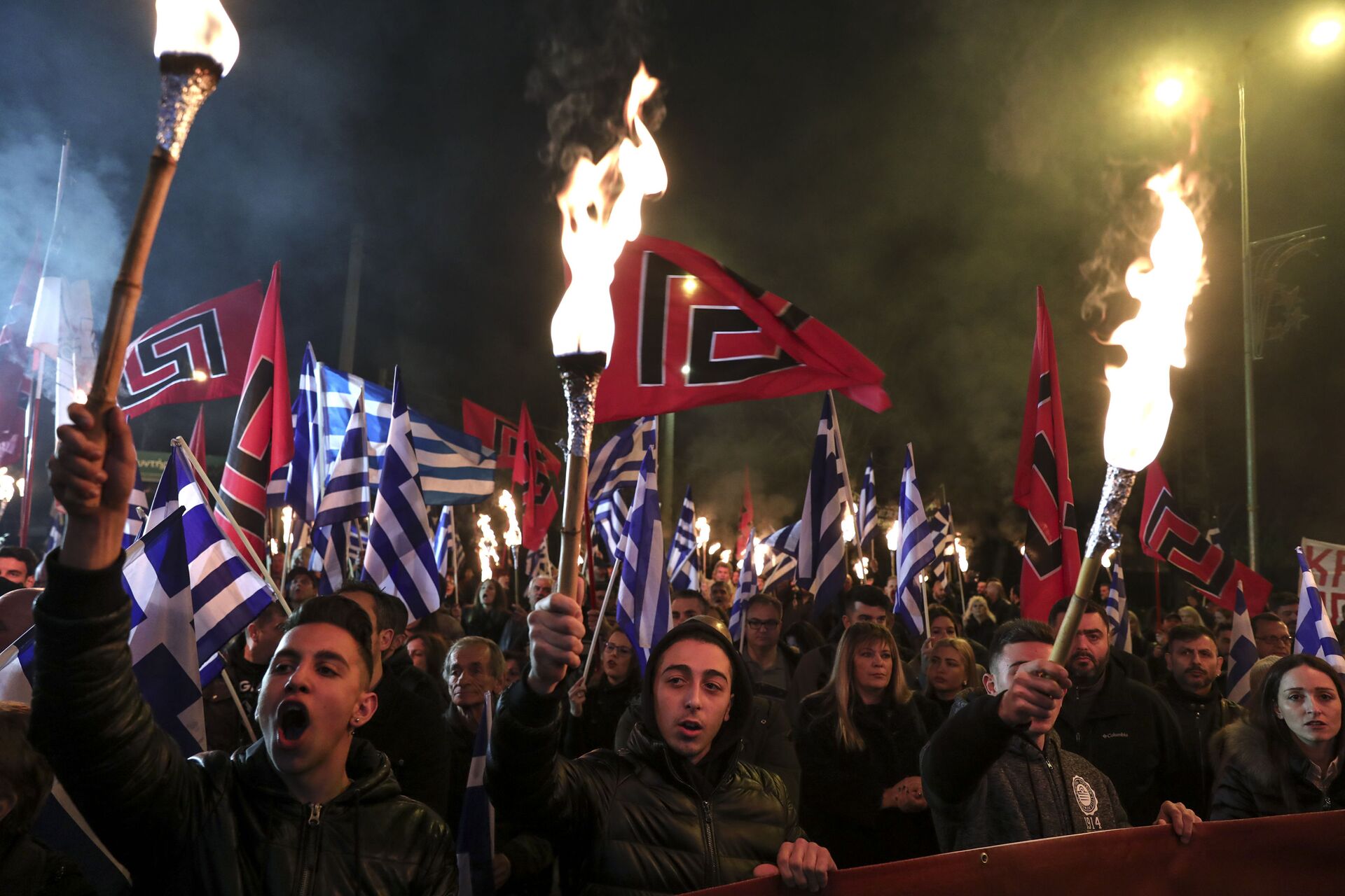 Supporters of Greece's extreme right Golden Dawn raise torches during a rally commemorating a 1996 military incident which cost the lives of three Greek navy officers and brought Greece and Turkey to the brink of war, in Athens, on Saturday, Feb. 2, 2019 - Sputnik International, 1920, 04.10.2021