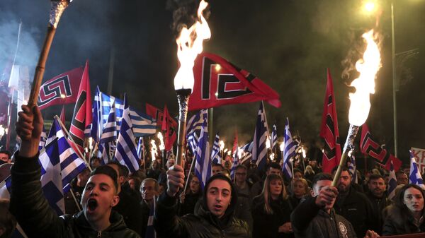 Supporters of Greece's Golden Dawn raise torches during a rally commemorating a 1996 military incident which cost the lives of three Greek navy officers and brought Greece and Turkey to the brink of war, in Athens, on Saturday, Feb. 2, 2019 - Sputnik International