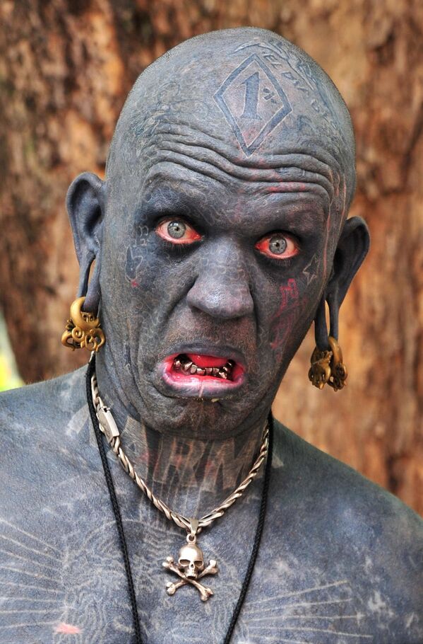 Lucky Diamond Rich from New Zealand, who in 2006 earned the Guinness World Record as the world's most tattooed person. His body is 100 per cent tattooed, including the insides of his eyelids, mouth, ears and foreskin.    - Sputnik International